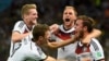 Germany's Mario Goetze celebrates his goal against Argentina with teammates (L-R) Andre Schuerrle ,Thomas Mueller and Benedikt Hoewedes during extra time in their 2014 World Cup final at the Maracana stadium in Rio de Janeiro July 13, 2014. 