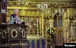FILE - Archbishop of Canterbury Justin Welby gives and address during an Armistice Service at Westminster Abbey in Westminster, London, Nov. 11, 2018.