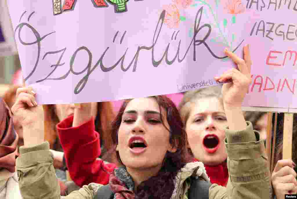 Demonstrators hold banners and shout slogans during a rally to mark International Women's Day in Ankara