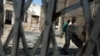 A street child wonders inside a burnt shop in Kisumu, western Kenya, in this picture taken Feb. 15, 2008. 