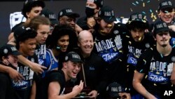 UCLA celebrates its win over Michigan in the college basketball tournament quarterfinals on March 31, 2021. (AP Photo/Michael Conroy)