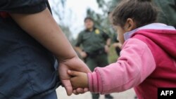 FILE - U.S. Border Patrol agents take Central American immigrants into custody near McAllen, Texas, Jan. 04, 2017.