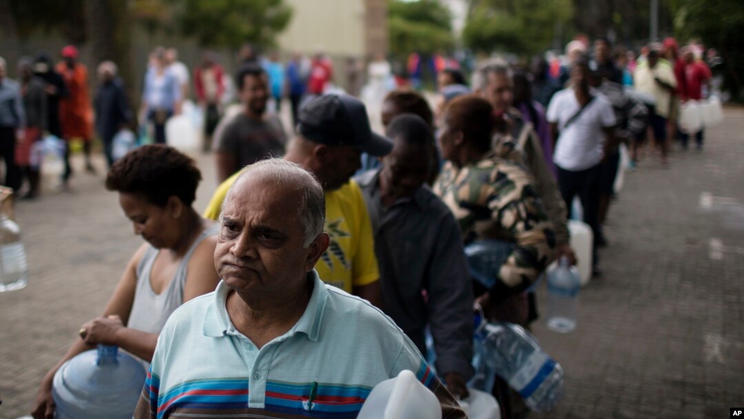 Residents queue to fill containers with water from a source of natural spring water in Cape Town, South Africa, Feb. 2, 2018. 