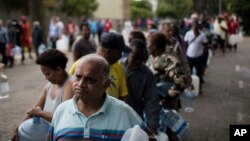 Residents queue to fill containers with water from a source of natural spring water in Cape Town, South Africa, Feb. 2, 2018. 