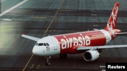 FILE - An AirAsia plane is seen on a runway at Kuala Lumpur International Airport, August 2014.