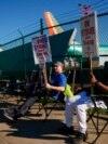 FILE - Boeing 737 Max aircrafts are seen behind fences as striking Boeing workers picket on Sept. 24, 2024, next to the company's facilities in Renton, Washington. Analysts say strikes and two hurricanes kept employers from adding many jobs in October.