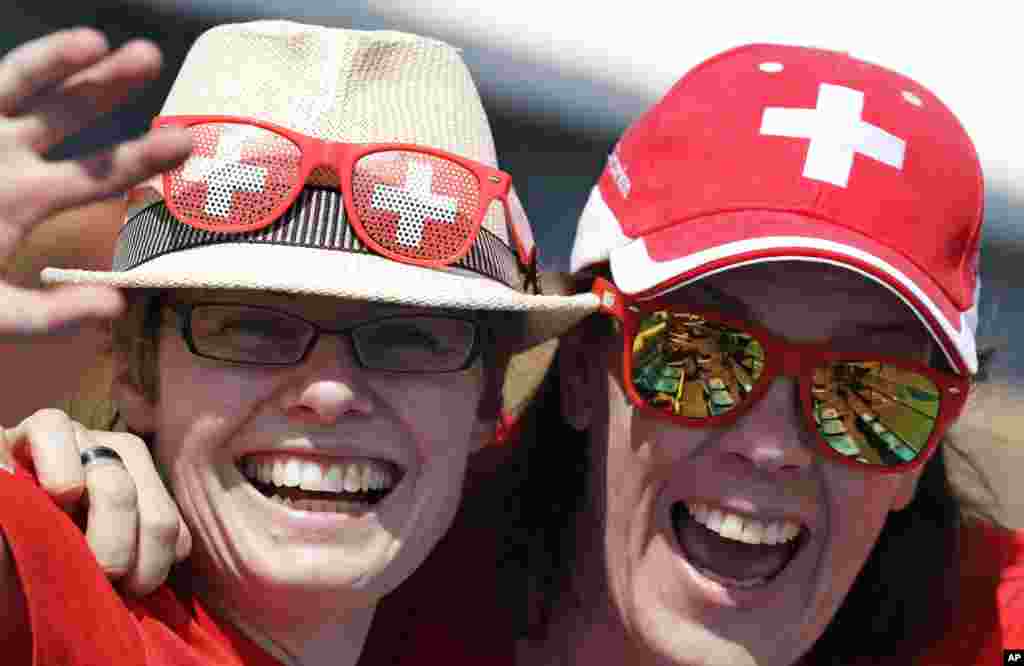 Swiss fans smile as they wait for the start of a match between Timea Bacsinszky, of Switzerland, and Zhang Shuai, of China, the 2016 Summer Olympics in Rio de Janeiro, Brazil, Aug. 6, 2016. 