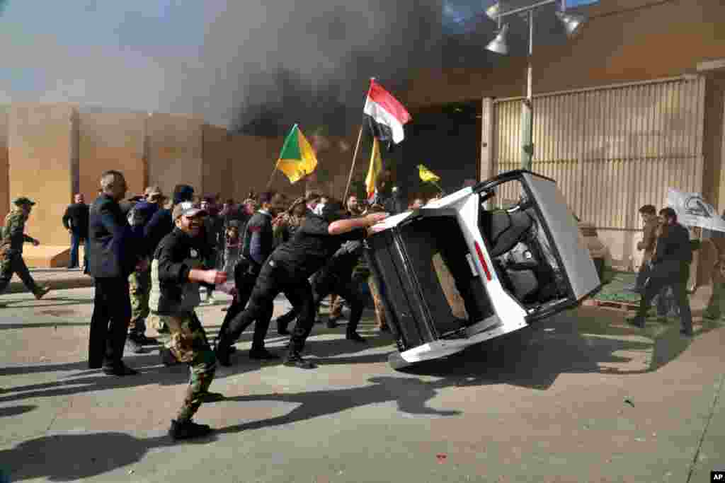 Dozens of angry Iraqi Shi&#39;ite militia supporters damage property inside the U.S. embassy compound in Baghdad, Iraq, Dec 31, 2019.