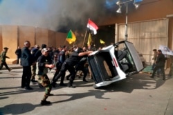 Protesters damage property inside the U.S. embassy compound, in Baghdad, Iraq, Tuesday, Dec 31, 2019.