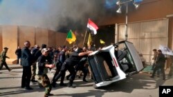 Protesters damage property inside the U.S. Embassy compound, in Baghdad, Dec 31, 2019. 