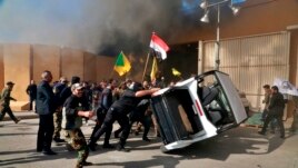 Protesters damage property inside the U.S. embassy compound, in Baghdad, Iraq, Tuesday, Dec 31, 2019.