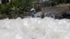 An Indonesian man carries used plastics to be sold to a recycling center, as he walks in front of discarded plastic bags, in Jakarta, Indonesia, Thursday, Dec 6, 2007. Delegates from 190 nations have assembled on the resort island of Bali, Indonesia…