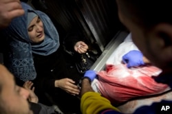 A Palestinian relative reacts after seeing the body of Adham Emara, 17, who was shot and killed by Israeli troops during a protest next to the Israeli border in the eastern Gaza Strip, in the morgue of the Shifa hospital in Gaza City, March 30, 2019.