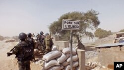 FILE - Cameroonian soldiers stand guard at a lookout post as they take part in operations against Boko Haram militants on Elbeid bridge that separates northern Cameroon form Nigeria's Borno state near the village of Fotokol, Cameroon, Feb. 25, 2015.