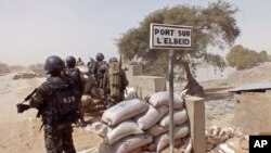 FILE - Cameroonian soldiers stand guard at a lookout post as they take part in operations against Boko Haram militants on Elbeid bridge that separates northern Cameroon form Nigeria's Borno state near the village of Fotokol, Cameroon, Feb. 25, 2015.