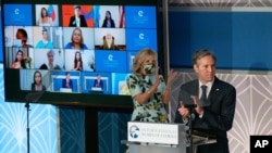 Secretary of State Antony Blinken and first lady Jill Biden, applaud during the 2021 International Women of Courage (IWOC) Award virtual ceremony at the State Department in Washington, Monday, March 8, 2021. (AP Photo/Manuel Balce Ceneta, Pool)