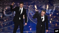 Josh Singer, left, and Tom McCarthy accept the award for best original screenplay for “Spotlight” at the Oscars on Feb. 28, 2016, at the Dolby Theatre in Los Angeles.