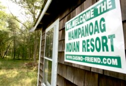 FILE: A poster declaring support for bringing a casino to Middleborough, Mass., appears on the side of a small house on property adjacent to land belonging to the Mashpee Wampanoag tribe.