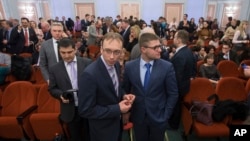 FILE - Jehovah's Witnesses wait in a courtroom in Moscow, Russia, April 20, 2017. Russia's Supreme Court has banned the religious group from operating in the country.