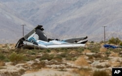 Wreckage lies near the place where a Virgin Galactic space tourism rocket, SpaceShipTwo, exploded and crashed in Mojave, Calif., Oct. 31, 2014.