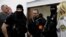 FILE - Miroslav Marcek walks inside the courtroom at a preliminary hearing on charges of ordering and carrying out the murders of investigative journalist Jan Kuciak and his fiancee Martina Kusnirova, in Pezinok, Slovakia, Dec, 19, 2019.