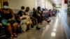 FILE - People queue to get vaccinated against COVID-19, at Lenasia South Hospital, near Johannesburg, South Africa, Dec. 1, 2021.