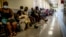 FILE - People queue to get vaccinated against COVID-19, at Lenasia South Hospital, near Johannesburg, South Africa, Dec. 1, 2021.