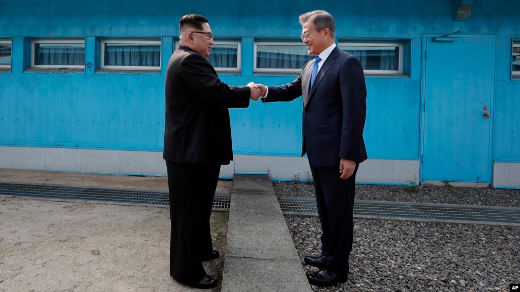 Lãnh tụ Bắc Hàn Kim Jong Un bắt tay Tổng thống Hàn Quốc Moon Jae-in qua lằn ranh quân sự trên biên giới, trước khi lần đầu đặt chân tới miền nam hôm 27/4.