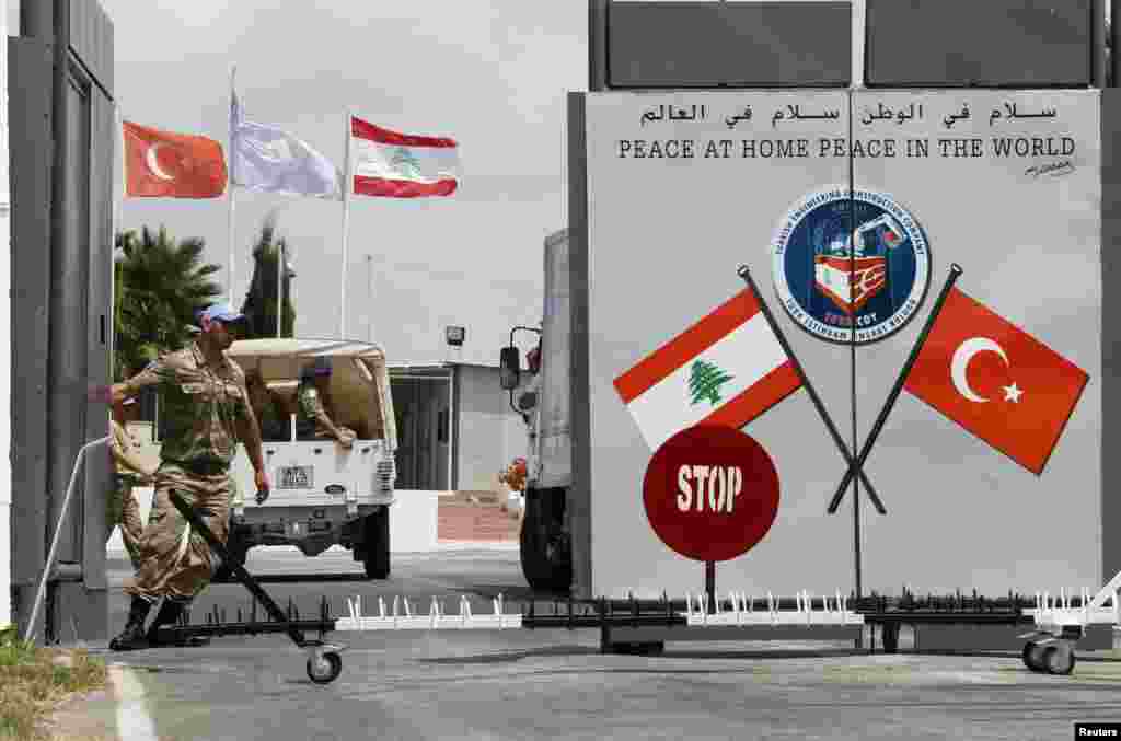 A Turkish peacekeeper of the United Nations Interim Force in Lebanon (UNIFIL) closes a gate of the Turkish Engineering Construction Company (TURKCOY) of UNIFIL in the village of Shaaytiyeh, southern Lebanon.