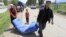 Uighur residents carry a temporary tent being distributed by the rescue team after an earthquake, in Nalati township, Xinjiang Uighur Autonomous Region June 30, 2012. 