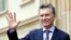 FILE - Argentina's President Mauricio Macri waves at journalists at the end of a welcoming ceremony at the Presidential Palace in Bogota, Colombia, June 15, 2016.