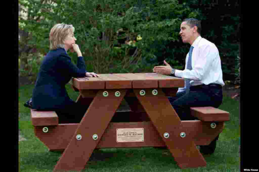 President Barack Obama and Secretary of State Hillary Rodham Clinton speak together sitting at a picnic table, on the South Lawn of the White House, May 9, 2009. ( White House/Pete Souza)