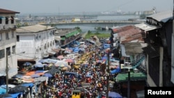 FILE - Christmas shoppers flock to a market despite concerns over Ebola in Monrovia, Liberia, Dec. 23, 2014. 