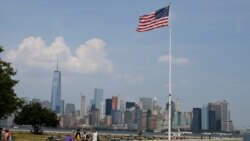 FILE - Tourists view the New York City skyline from Ellis Island, July 29, 2015, in New York. The island, situated in New York harbor, served as an entry point for immigrants to the U.S. from 1892 through 1954.