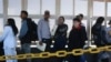 Migrants wait in line for US agents to examine their documents requesting an appointment to apply for asylum, at the Paso del Norte international bridge, in Ciudad Juarez, Mexico, Nov. 1, 2024. 