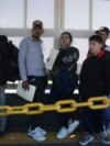 Migrants wait in line for US agents to examine their documents requesting an appointment to apply for asylum, at the Paso del Norte international bridge, in Ciudad Juarez, Mexico, Nov. 1, 2024. 
