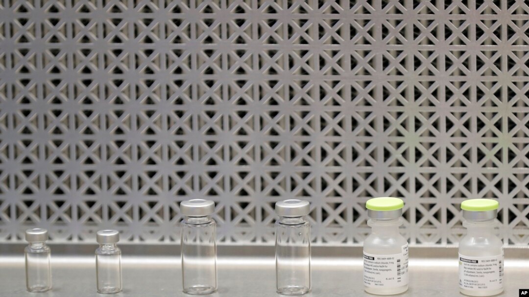Vials used by pharmacists to prepare syringes used on the first day of a first-stage safety study clinical trial of the potential vaccine for COVID-19, the disease caused by the new coronavirus, rest on a lab table at the Kaiser Permanente…