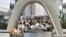 People pray in front of the cenotaph for the victims of the 1945 atomic bombing at Peace Memorial Park in Hiroshima, western Japan, in this photo taken by Kyodo, Aug. 6, 2016.