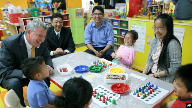 na této fotografii z 27. května 2014 navštíví starosta New Yorku Bill de Blasio třídu před mateřskou školou v Brooklyn Chinese American Association Early Childhood Education Center v Sunset parku v Brooklynu v New Yorku. (AP Photo/Newsday, Linda Rosier, bazén, soubor)