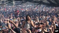 FILE - Partygoers listen to live music on the second of two days at the annual 4/20 marijuana festival in Denver, April 20, 2014. Colorado is now one of four states in the United States that allows recreational use of marijuana.