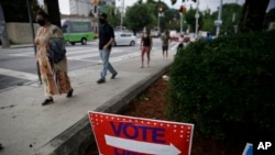 People wait in a line to vote in Georgia's primary election at Park Tavern in Atlanta, June 9, 2020.