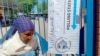 A woman leaves a polling station after casting her vote in Kumakwane, Botswana, near Gaborone, on Oct. 30, 2024.