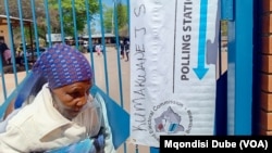 A woman leaves a polling station after casting her vote in Kumakwane, Botswana, near Gaborone, on Oct. 30, 2024.