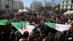 People take part in a protest demanding immediate political change in Algiers, Algeria, March 12, 2019.