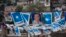 Banners with a portrait of Honduran President and current presidential candidate Juan Orlando Hernandez hang outside a polling station during the general elections in Tegucigalpa, Nov. 26, 2017.