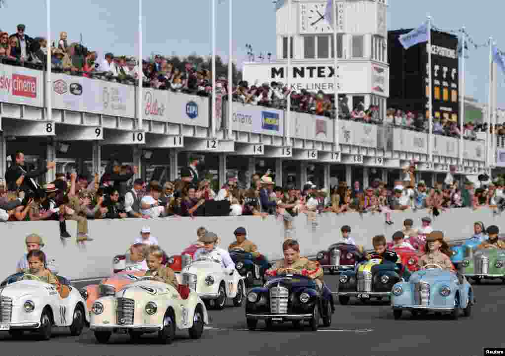 Children take part in the Settrington Cup Pedal Car Race as motoring enthusiasts attend the Goodwood Revival, a three-day historic car racing festival in Goodwood, Chichester, southern Britain, Sept.18, 2021.