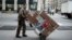 FILE - A UPS delivery man is seen pushing a trolley of packages in New York City.