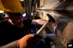 FILE - A Greek worker, part of team of experts, begins renovation of Jesus' tomb in the Church of the Holy Sepulchre in Jerusalem's old city, June 6, 2016.