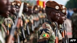 FILE - Malian soldiers take part in a ceremony in Bamako, Sept. 22, 2018. Fifty-four people were killed in an attack on a Mali military post in the northeast of the country on Nov. 1, 2019.