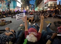 Protestors lay in the street to stage a die-in at Herald Square, Wednesday, April 29, 2015, in New York. Several hundred people gathered in New York to protest the death of Freddie Gray in Baltimore..